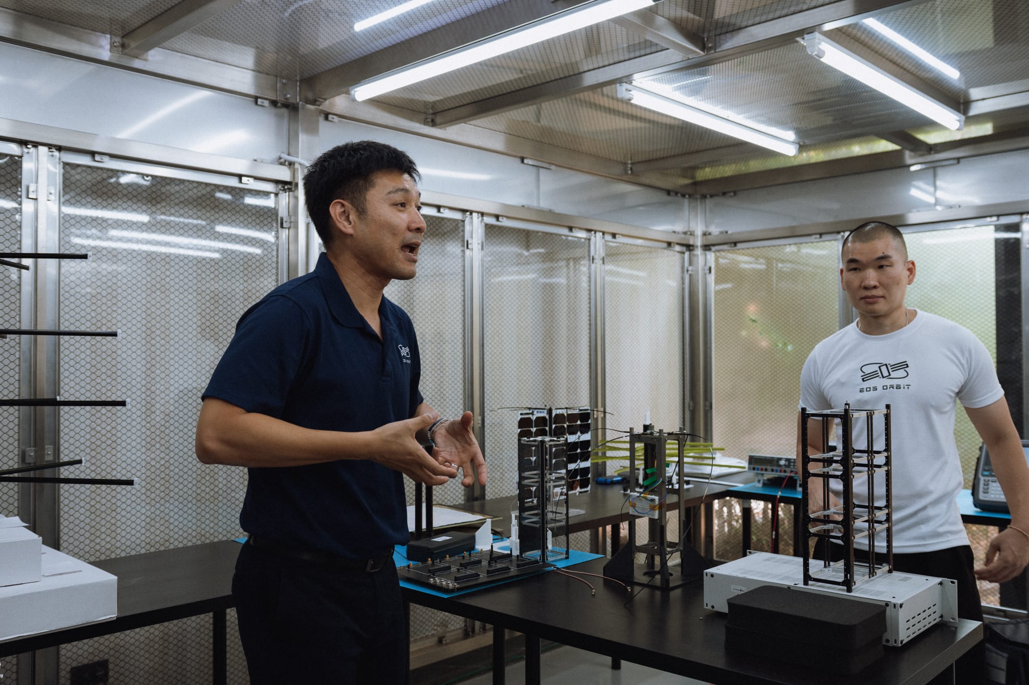 EOS Orbit founders reviewing flight hardware in the company clean room